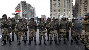 This is why the Egyptian army is peculiar. It is an awkward in-between institution standing somewhere between society and the political realm. (Image: Hassan Ammar/AP)
