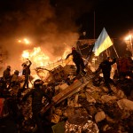 SState_flag_of_Ukraine_carried_by_a_protester_to_the_heart_of_developing_clashes_in_Kyiv,_Ukraine._Events_of_February_18,_2014